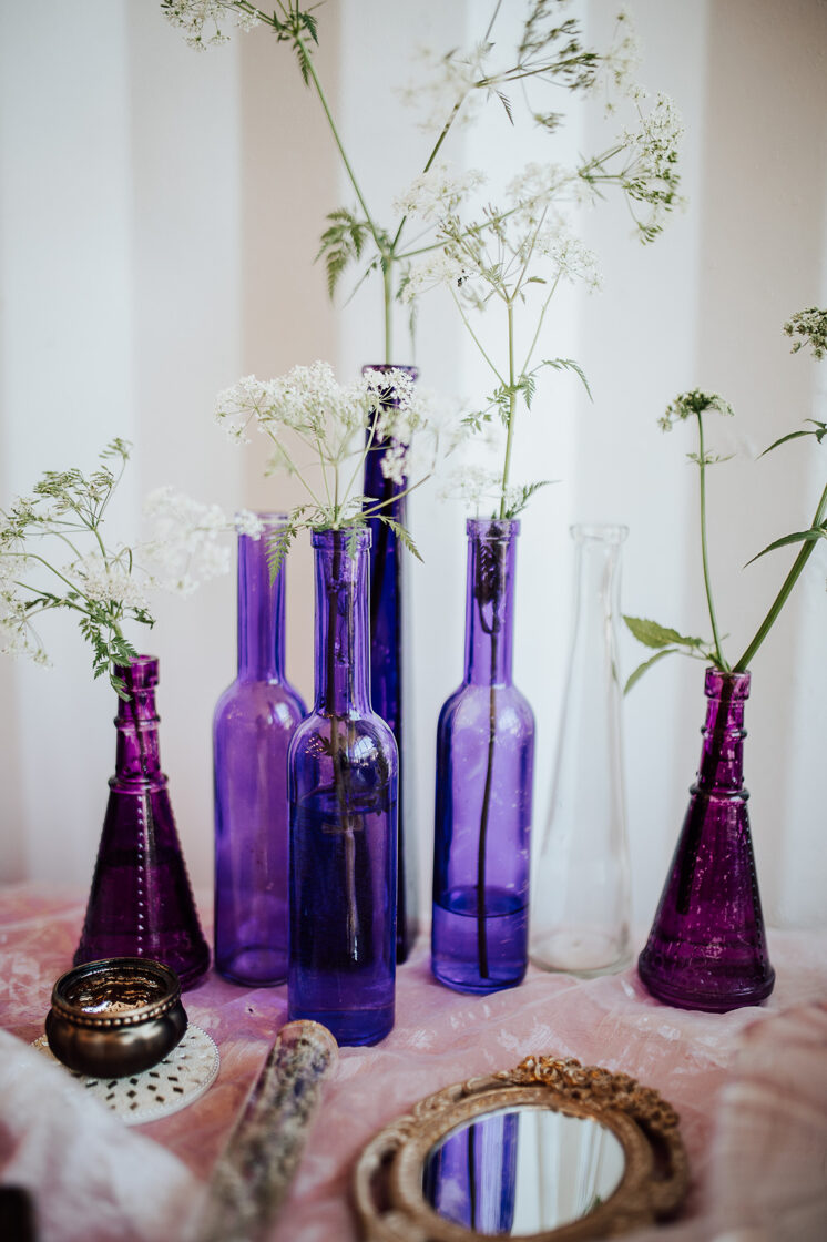 Violetas un rozā stikla pudeles